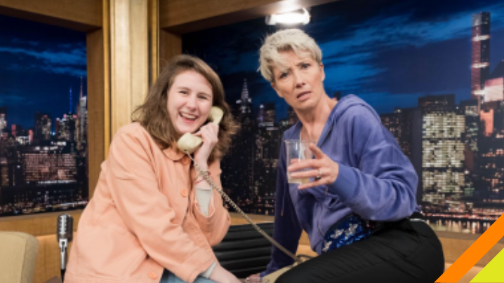 Student and professional actress sitting on desk.  